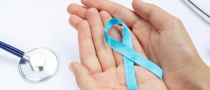 close-up-hands-holding-blue-ribbon-with-stethoscope